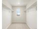 Walk in closet with neutral walls, carpet floor, window and shelving on both sides at 22340 E 8Th Ave, Aurora, CO 80018