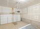 Unfinished garage with a white garage door, concrete floor, and an automatic garage door opener at 22340 E 8Th Ave, Aurora, CO 80018