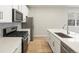 Well-designed kitchen featuring white cabinets, modern appliances, and a functional island at 22340 E 8Th Ave, Aurora, CO 80018