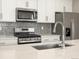 Close-up of the kitchen, featuring stainless steel appliances and a tile backsplash at 22340 E 8Th Ave, Aurora, CO 80018