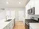 Contemporary kitchen with stainless steel appliances and a large quartz countertop island at 22340 E 8Th Ave, Aurora, CO 80018