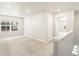 Bright living room features neutral walls, carpet, natural light from window and leads to another room at 22340 E 8Th Ave, Aurora, CO 80018