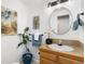 Bathroom featuring stylish light fixtures, a round mirror and decor at 5425 County Road 32 # 27, Mead, CO 80504