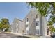 Exterior view of gray townhouse complex with white accents at 3436 S Locust St # D, Denver, CO 80222