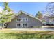 Side view of a modern home with a spacious yard and mature trees at 3436 S Locust St # D, Denver, CO 80222