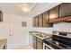 Kitchen featuring stainless steel appliances and dark wood cabinets at 3436 S Locust St # D, Denver, CO 80222