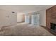 Carpeted living room showcasing a fireplace and sliding door access to the outside at 3436 S Locust St # D, Denver, CO 80222
