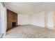 Bright, carpeted living room with a brick fireplace at 3436 S Locust St # D, Denver, CO 80222