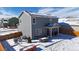 A cozy backyard in winter features an outdoor seating area and snow-covered ground at 14860 Guernsey Dr, Mead, CO 80542