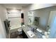 Stylish bathroom features a granite countertop vanity and a shower over tub with decorative shower curtain at 14860 Guernsey Dr, Mead, CO 80542