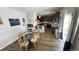 Open dining area with a modern table and chairs, adjacent to a well-equipped kitchen with dark cabinetry at 14860 Guernsey Dr, Mead, CO 80542