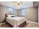 A neutral bedroom featuring a comfy bed with soft bedding, a window bringing in natural light, and carpeted floors at 6046 Vrain St, Arvada, CO 80003