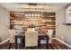Dining room featuring modern lighting, stylish table, and a decorative wood accent wall at 6046 Vrain St, Arvada, CO 80003