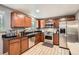 Well-lit kitchen boasts granite countertops, stainless appliances, and hardwood style floors at 6046 Vrain St, Arvada, CO 80003