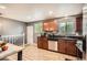 Updated kitchen features granite countertops, stainless steel appliances, and wood-look tile flooring at 6046 Vrain St, Arvada, CO 80003