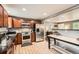 Spacious kitchen featuring granite countertops, stainless steel appliances, and wooden cabinets at 6046 Vrain St, Arvada, CO 80003