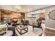 Bright living room flows to kitchen; features a dining area, modern furnishings, and wood accent wall at 6046 Vrain St, Arvada, CO 80003