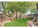Backyard with large trees, garden bed and stepping stone pathway at 7895 W 67Th Ave, Arvada, CO 80004