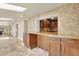 Stylish bar area featuring granite countertops, wooden cabinetry, and a pass-through to the kitchen at 7895 W 67Th Ave, Arvada, CO 80004