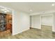 A finished basement with wood-look floors, offering a flexible living space and laundry area at 7895 W 67Th Ave, Arvada, CO 80004