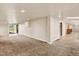 Spacious carpeted basement with recessed lighting, ample space, and outdoor access at 7895 W 67Th Ave, Arvada, CO 80004