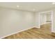 A neutral, open basement with wood-look floors, offering plenty of space for activities at 7895 W 67Th Ave, Arvada, CO 80004