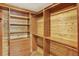 Spacious closet with custom wooden shelving and drawers for optimal storage at 7895 W 67Th Ave, Arvada, CO 80004