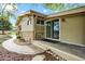 Exterior view showcasing a deck, sliding glass doors, and brick landscaping at 7895 W 67Th Ave, Arvada, CO 80004