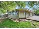Landscaped backyard with stone patio, garden and ample lawn space at 7895 W 67Th Ave, Arvada, CO 80004