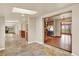 Open hallway with tiled floor leading to kitchen and living spaces, enhancing the home's flow at 7895 W 67Th Ave, Arvada, CO 80004
