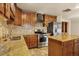 Modern kitchen with stainless steel appliances, granite countertops, and tiled backsplash at 7895 W 67Th Ave, Arvada, CO 80004