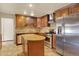 Kitchen featuring stainless steel appliances, tile floors, and a kitchen island at 7895 W 67Th Ave, Arvada, CO 80004
