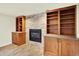 Living room with a stone fireplace and built-in bookshelves at 7895 W 67Th Ave, Arvada, CO 80004