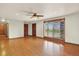 Bright living room with hardwood flooring, a large window, and neutral color scheme at 7895 W 67Th Ave, Arvada, CO 80004