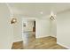 Open concept living room with hardwood floors, modern lighting, and trim work at 7895 W 67Th Ave, Arvada, CO 80004