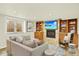 Cozy living room with fireplace, built-in shelving, and comfortable seating at 7895 W 67Th Ave, Arvada, CO 80004
