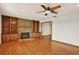 Elegant living room featuring hardwood floors and a fireplace with built-in cabinets at 7895 W 67Th Ave, Arvada, CO 80004