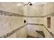 Elegant tiled shower with built-in niche and bench seating at 7895 W 67Th Ave, Arvada, CO 80004