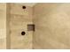 Glass enclosed shower with stone walls and a built in soap niche at 7895 W 67Th Ave, Arvada, CO 80004