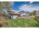 Spacious backyard featuring a well-maintained lawn and mature trees at 10440 W 83Rd Ave, Arvada, CO 80005