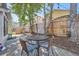 Private backyard featuring a seating area, mature trees, and a wooden fence at 10440 W 83Rd Ave, Arvada, CO 80005
