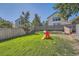 Landscaped backyard featuring a grassy lawn, playset, and mature trees at 10440 W 83Rd Ave, Arvada, CO 80005