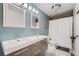 Contemporary bathroom with double vanity, modern fixtures, and a tiled shower/tub combo at 10440 W 83Rd Ave, Arvada, CO 80005