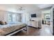 Spacious bedroom with hardwood floors, neutral walls, a ceiling fan, closet and lots of natural light at 10440 W 83Rd Ave, Arvada, CO 80005