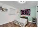 Simple bedroom with a comfortable bed, wood floors, and bright natural light at 10440 W 83Rd Ave, Arvada, CO 80005