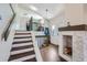 Inviting entryway with a staircase and a cozy fireplace at 10440 W 83Rd Ave, Arvada, CO 80005