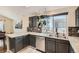 Kitchen with gray cabinets, stainless steel appliances, marble countertops, and a sink with backyard view at 10440 W 83Rd Ave, Arvada, CO 80005