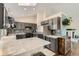 Bright kitchen with gray cabinets, marble countertop island, stainless steel appliances, and skylight at 10440 W 83Rd Ave, Arvada, CO 80005