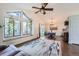 Spacious living room with large windows and a modern ceiling fan at 10440 W 83Rd Ave, Arvada, CO 80005