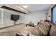 Comfortable living room showcasing a plush leather sofa, TV, and window at 10440 W 83Rd Ave, Arvada, CO 80005